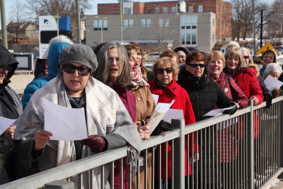 The local Canadian Federation of University Women marked today's International Women's Day with a march downtown and rendition of the national anthem at the Water Street Bridge.  Greg King for NewmarketToday