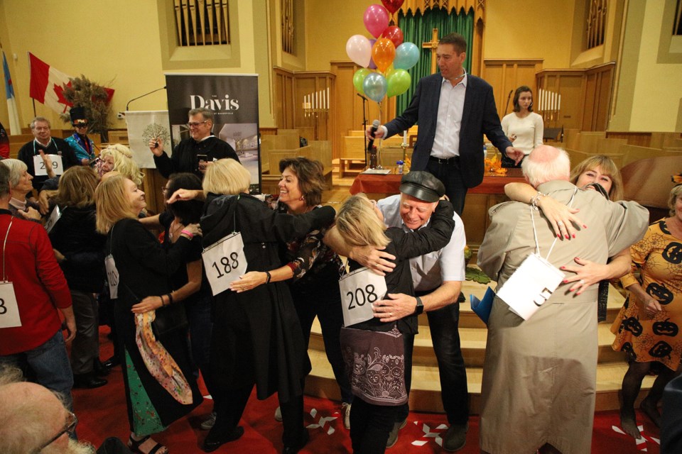 More than 4,000 hugs helped Newmarket smash the Guinness world record yesterday for the most hugs by a team of eight in 60 minutes at Trinity United Church. Greg King for NewmarketToday