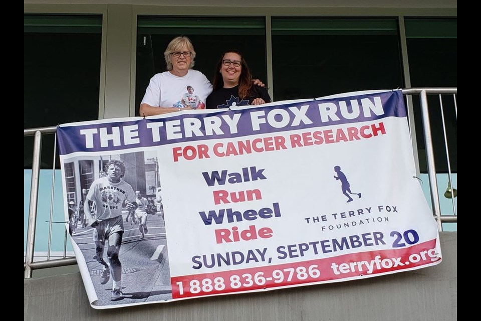 Terry Fox Run Newmarket volunteers Laurie Osborne (left) and Muriel Lee are shown here with the promotional banner at Buckley Insurance Brokers. Supplied photo