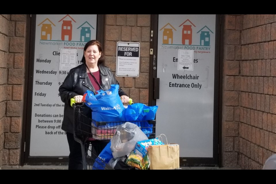 Shelly McConville delivers donations gathered at her full moon event to the Newmarket Food Pantry. 