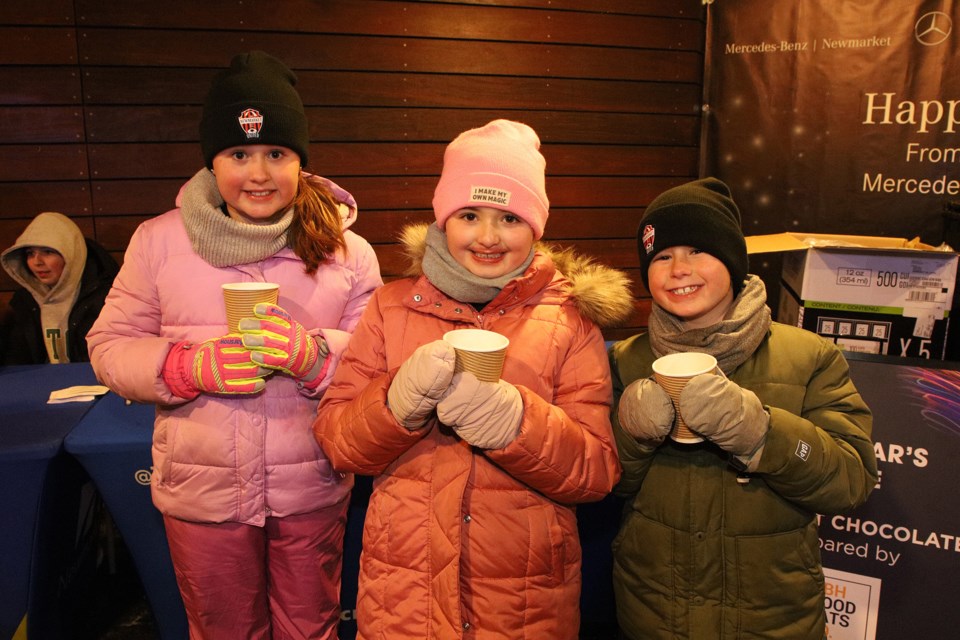 Emma, Brenna and Hunter Chown enjoy their free hot chocolate, courtesy of HBH Good Eats, at the Newmarket mayor's levee at Riverwalk Commons Friday, Jan. 13.  Greg King for NewmarketToday