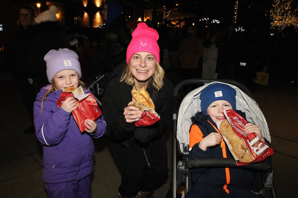 The longest line-up was for beavertails at Newmarket Mayor John Taylor's New Year's Levee Friday night, which was rescheduled due to a January storm. Michelle Wilson with kids Charlotte and William enjoy their treat.