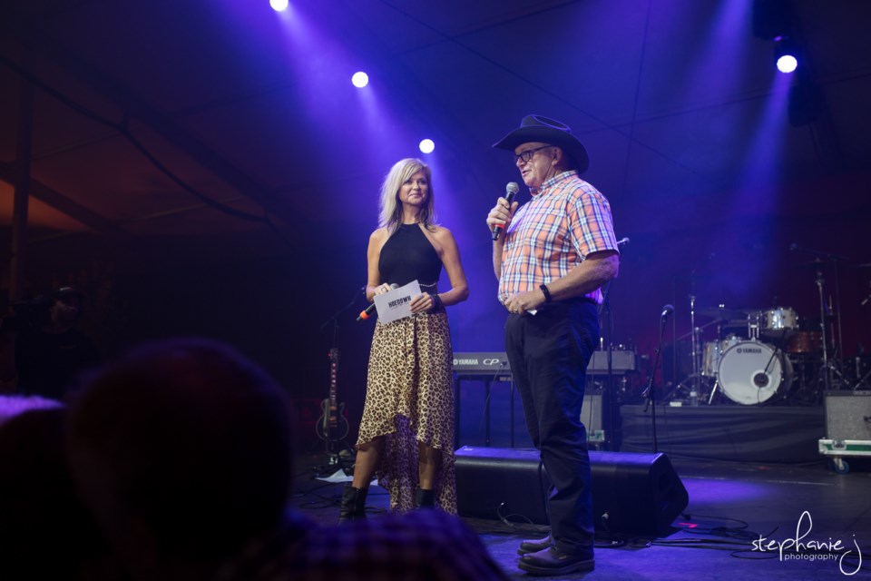 Steve Hinder, former Magna Hoedown chair, and Beverley Mahood, country artist and Hoedown emcee, take to the stage in 2018. Photo provided by Stephanie J. Photography