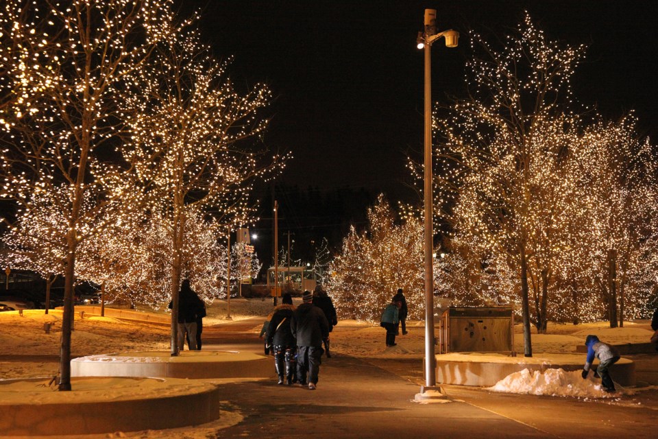 Strolling on the pathway aglow with lights on Riverwalk Commons.  Greg King for NewmarketToday