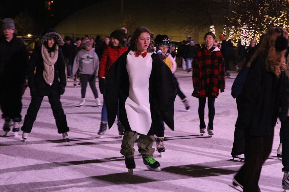 A "penguin" joins the skaters on the outdoor rink in downtown Newmarket last night for the first of the  Frozen Fridays this month.