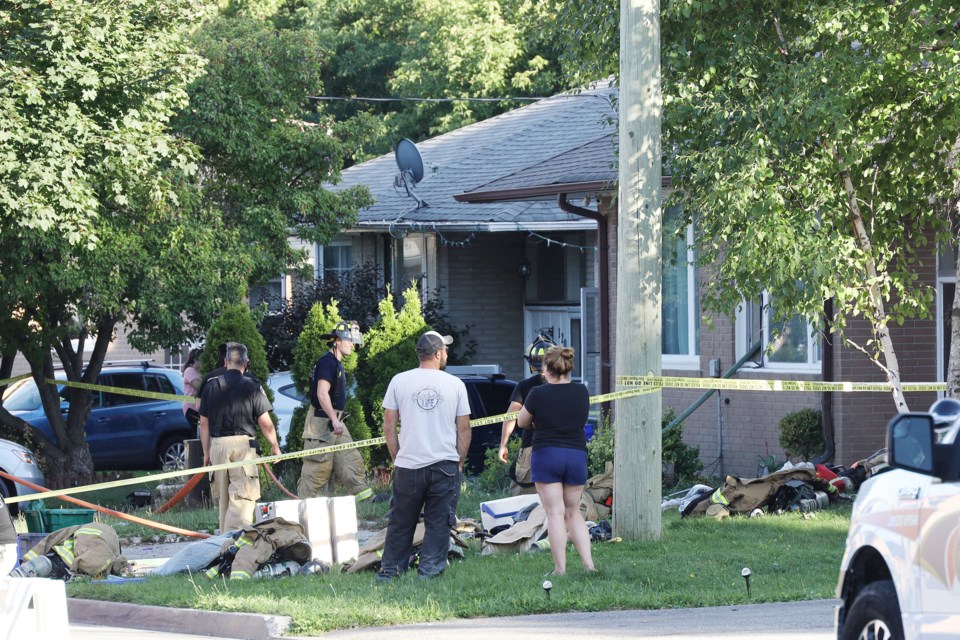 Neighbours gathered after Central York Fire Services crews extinguished a fire at the rear of the Sheldon Avenue house in Newmarket Sept. 2. Greg King for NewmarketToday