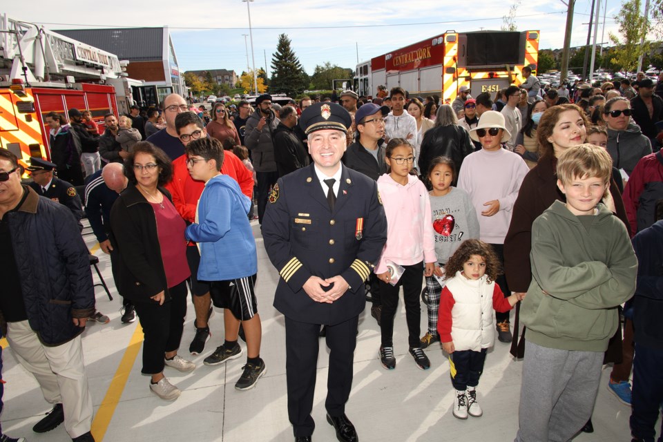 Central York Fire Services Deputy Chief Rocco Volpe stands with families waiting for the Fire Station 4-5 open house to begin Saturday, Sept. 24.  Greg King for NewmarketToday