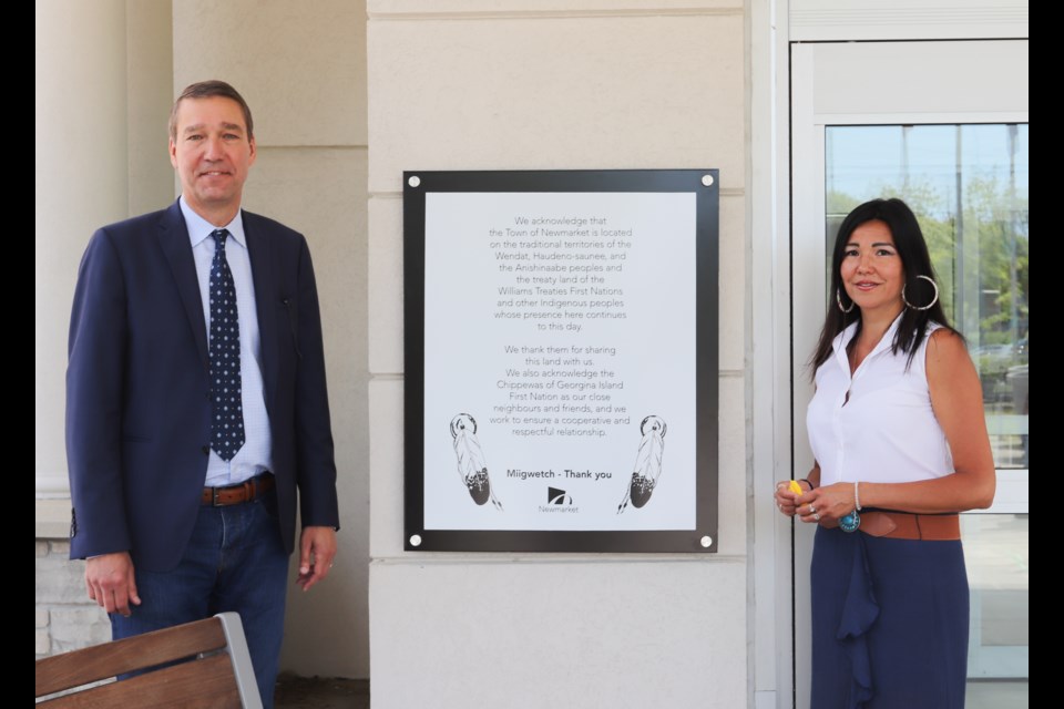 Newmarket Mayor John Taylor and Chief Donna Big Canoe of the Chippewas of Georgina Island First Nation with the newly unveiled land acknowledgement plaque, which expresses gratitude to all Indigenous peoples for sharing their lands, at the Town of Newmarket offices this morning. Sylvie Lessard for NewmarketToday  