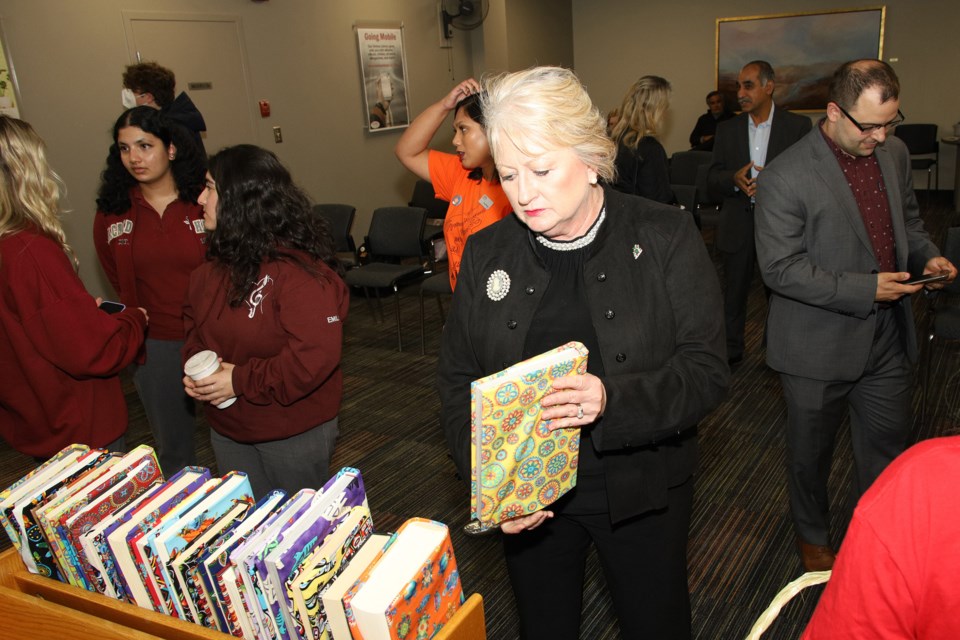 Newmarket-Aurora MPP Dawn Gallagher Murphy takes a closer look at some of the books in the Canadian Library exhibit opening Sept. 28 at Newmarket Public Library.  Greg King for NewmarketToday