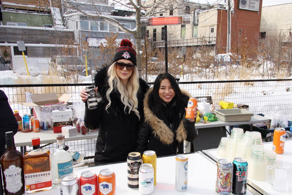 Brave outdoor servers Alice Beechener and Minh Nguyen are shown here at Riverwalk Commons during the first winter edition of Newmarket's Craft Beer Festival. The winter beer fest ran Feb. 28 and 29 and was organized by local residents Carl Milroy and Michelle Planche.  Greg King for NewmarketToday