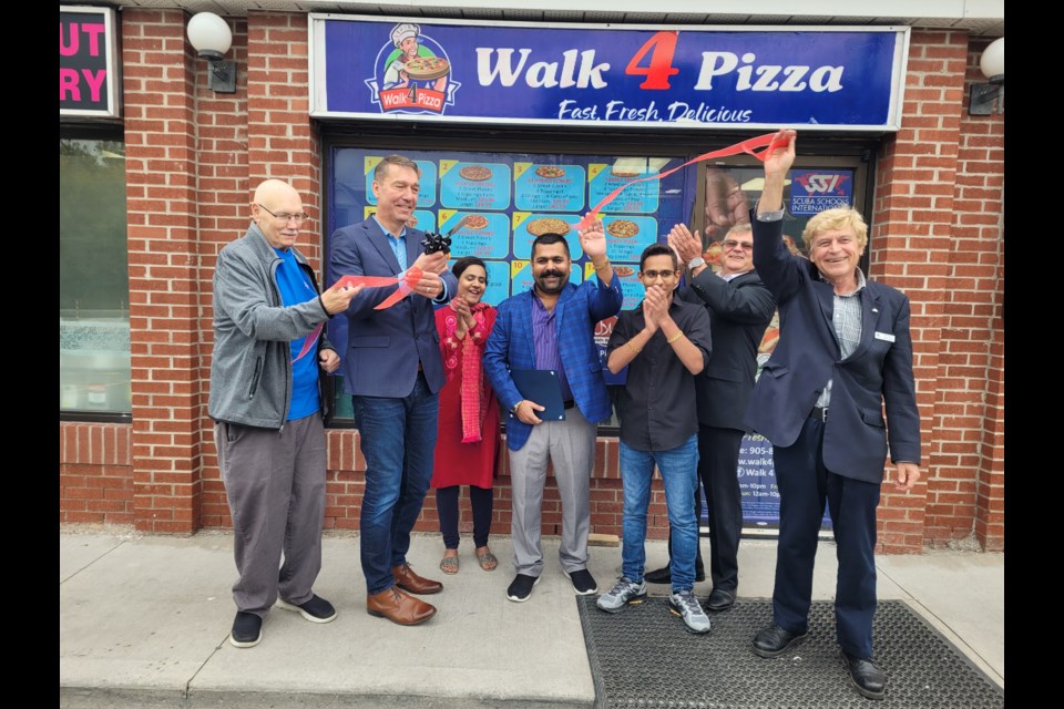 The ribbon is cut outside Walk 4 Pizza with the Abro family, Mayor John Taylor, ward councillor Bob Kwapis, and deputy mayor Tom Vegh.