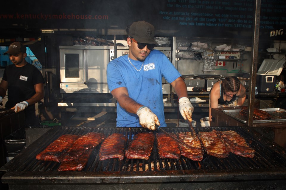 Kentucky Smokehouse's Nathan Monteiro prepares ribs at Newmarket's Ribfest May 27 at Upper Canada Mall. Greg King for NewmarketToday