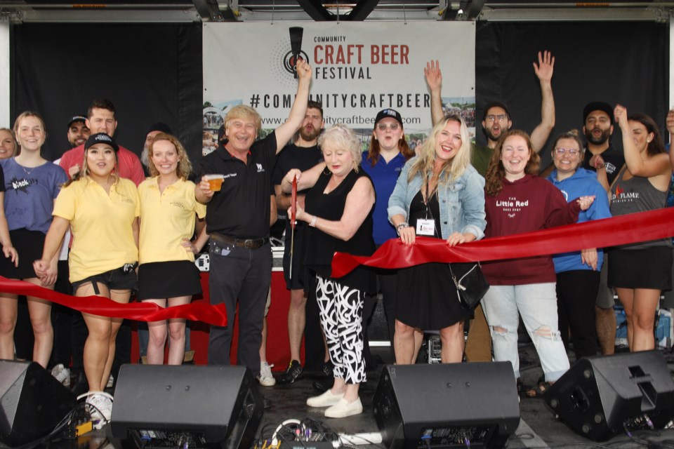 Vendors surround Newmarket Deputy Mayor Tom Vegh, Newmarket-Aurora MPP Dawn Gallagher Murphy, and Community Craft Beer Festivals president Michelle Planche as the ribbon is cut to kick off the Newmarket Community Craft Beer Festival this Friday and Saturday.  Greg King for NewmarketToday