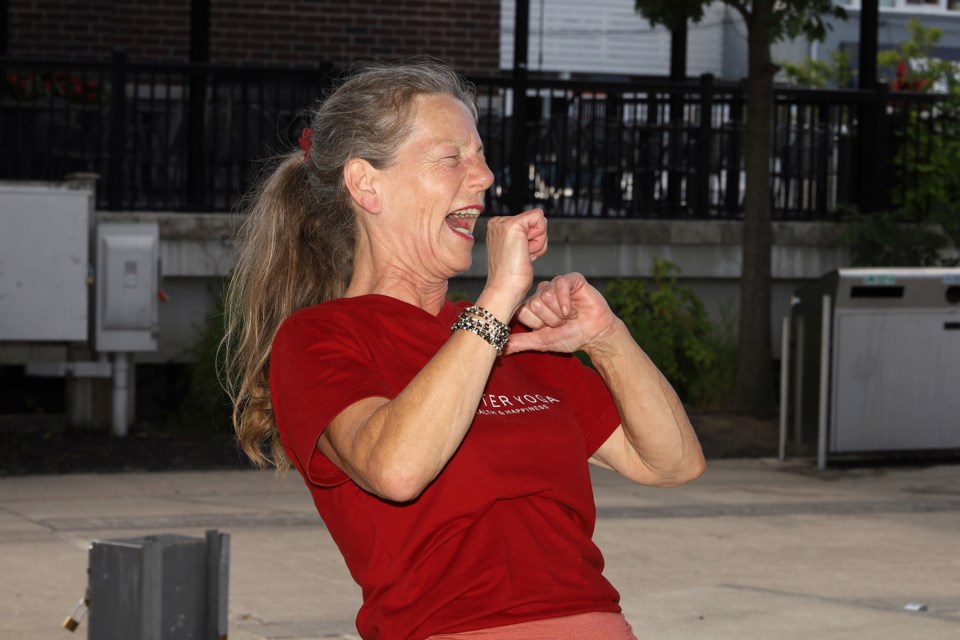 "Laughter Ambassador" Cathy Nesbitt laughs at herself at the free Laughter Yoga session she led Tuesday afternoon at Newmarket's Riverwalk Commons.  Greg King for NewmarketToday