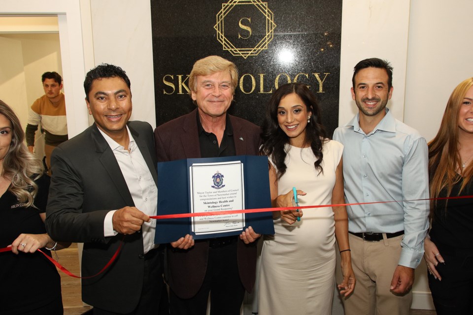 Dr. Amit Upadhyay, Newmarket Deputy Mayor Tom Vegh, Dr. Avneet Parmar, and Frank Rosso cut the ribbon at the grand re-opening of Skintology Health & Wellness Centre.  Greg King for NewmarketToday