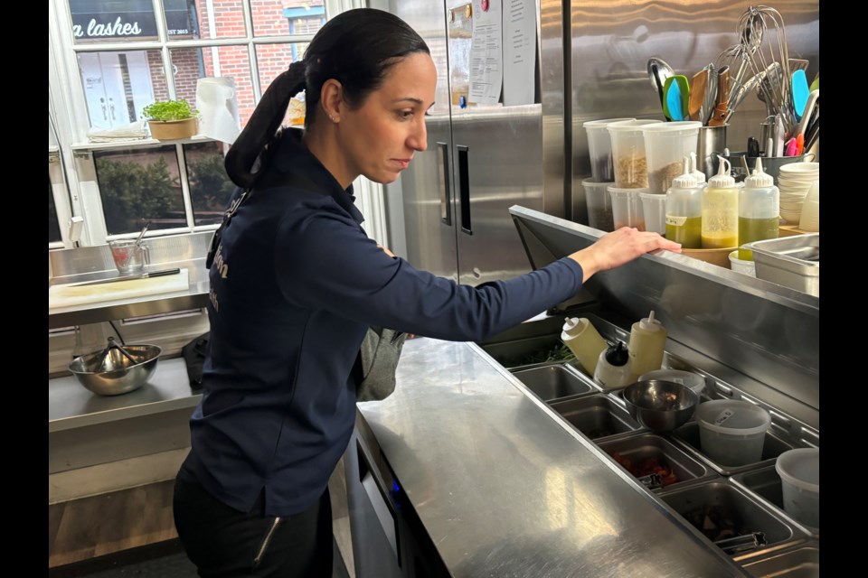 Marika Italiano, public health inspector checks to see if sauces and toppings are fresh.
