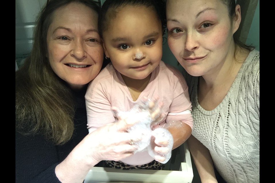 Three generations of Newmarket's Matthew family are shown here in a March 22, 2020 photo after a hand-washing sing-a-long. They are (from left) grandmother Debbie, Aliviah, 3, and mom Teran. Supplied photo