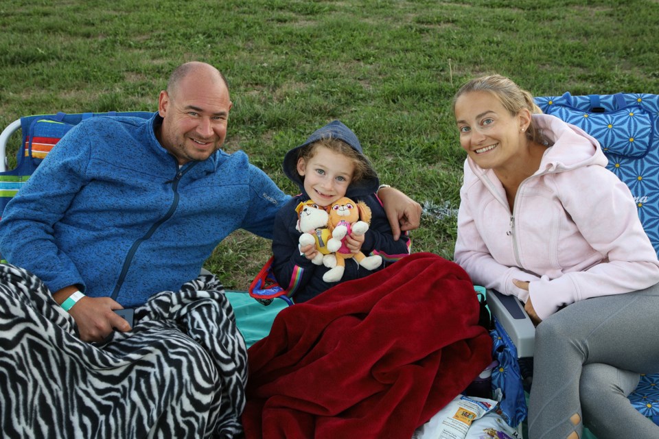 At Tuesday's Moonlight Movie, Tyler and Christine Ferguson with daughter Mackenzie, who is looking forward to starting Grade 2 in September and hopes to be in the same class as her best friend.  Greg King for NewmarketToday