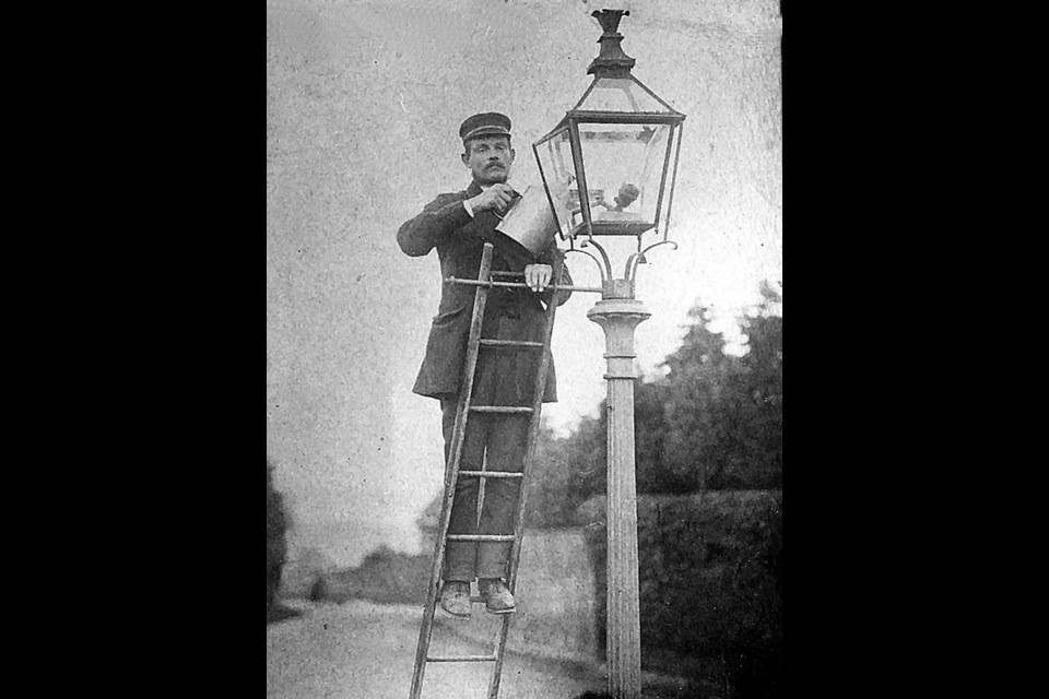 The town lamplighter went about each evening and morning, carrying a little ladder, a cloth for cleaning the lamp and a coal oil can after they were installed on Main Street in 1879.