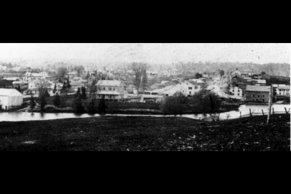 The earliest photograph of Newmarket, 1862, when it was a frontier town with a muddy Main Street — and the forest visible in the background.