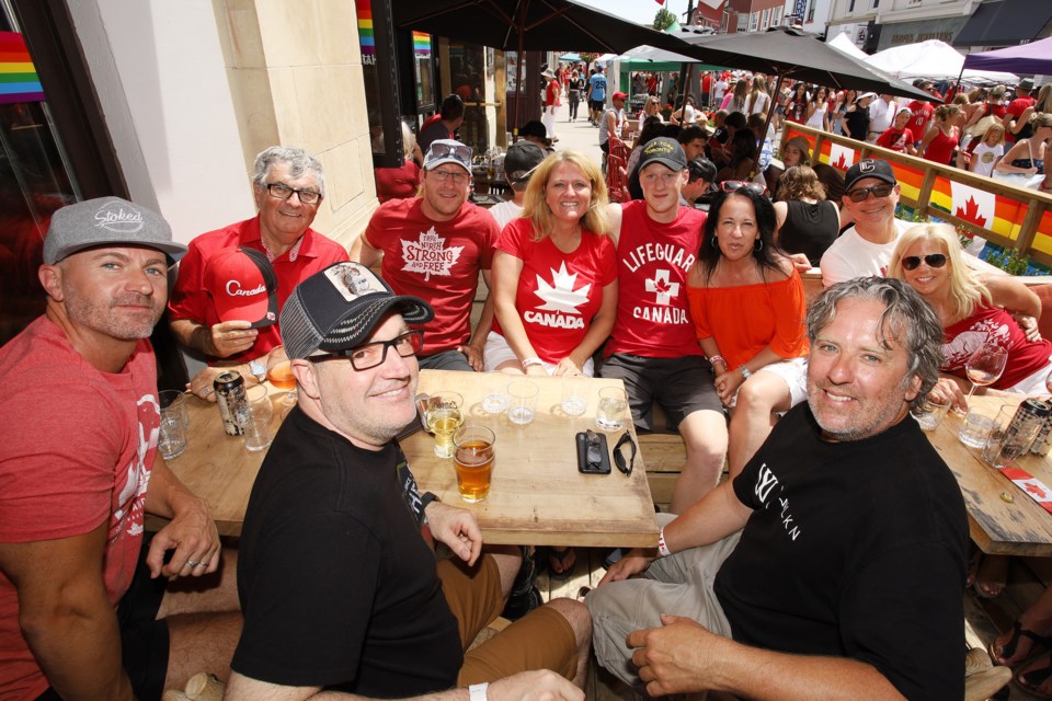 Mark McTavish (left) celebrates his 40th and Canada's 152nd birthday with family and friends on a Main Street patio.  Greg King for NewmarketToday