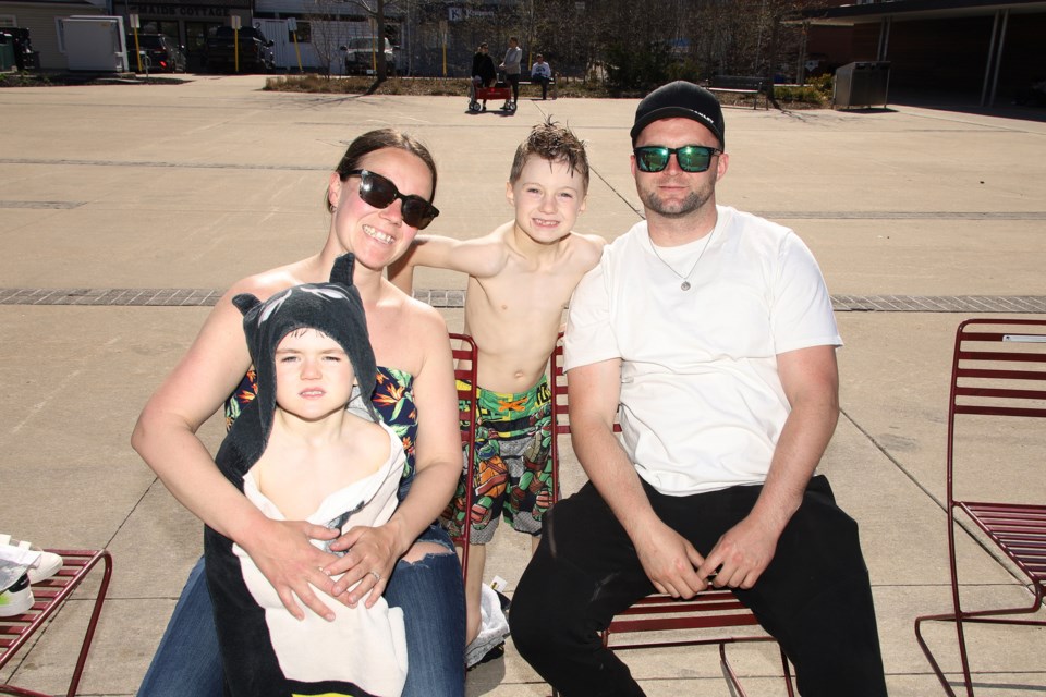 Celebrating a beautiful, warm Mother's Day 2022 are mom Carly Robinson with sons Patrick and Michael and husband Mason at the Tim Hortons Water Feature at Riverwalk Commons May 8.  Greg King for NewmarketToday