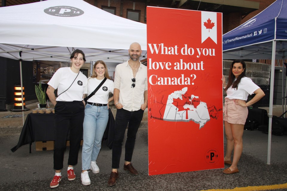 Ashlynn Mulligan, Emily, Oliver Osborne, and Sonya Singh were at the Streetcar booth on Main Street on July 1, Canada Day to tell residents about the plans for the boutique hotel in the former clock tower post office building.  Greg King for NewmarketToday