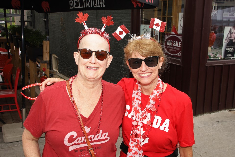 Mugs Zweerman and Teresa Bartschat celebrate Canada Day on Main Street Newmarket July 1.  Greg King for NewmarketToday