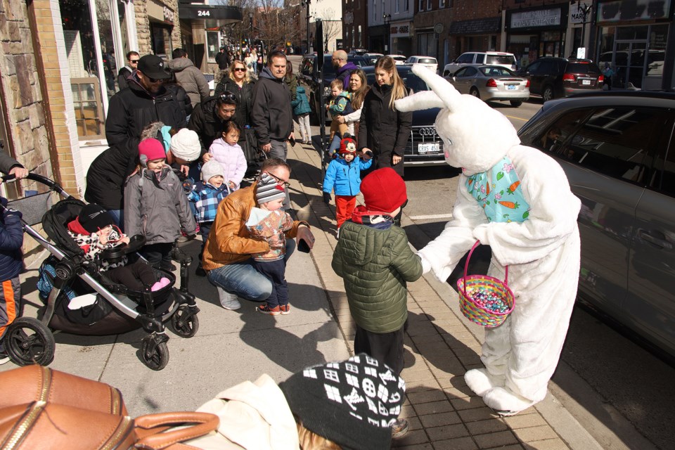 Kids flock the Easter Bunny handing out chocolate eggs at the Main Street Newmarket's Easter celebration Saturday afternoon.