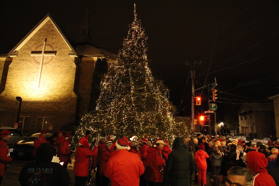 The town Christmas tree, on Water Street at the bottom of Main Street South at St. Andrew's Presbyterian Church, was lit last night, to the crowd's appreciation.  Greg King for NewmarketToday