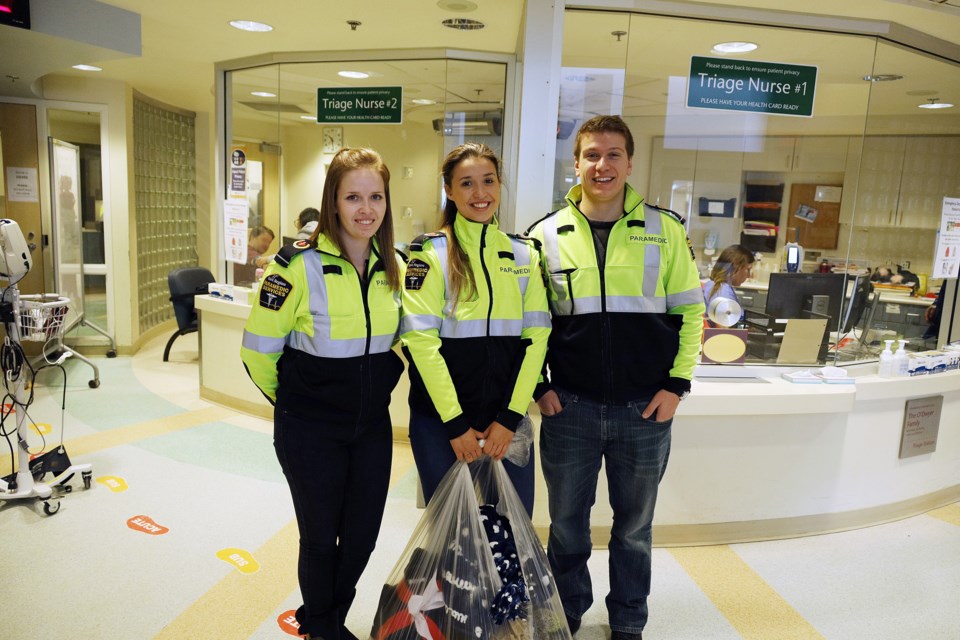 York Region paramedics Ciara Ryan, Veronica Conceicao and Rheiner Kammen make a special delivery of toys and blankets at Southlake Regional Health Centre today.  Greg King for NewmarketToday