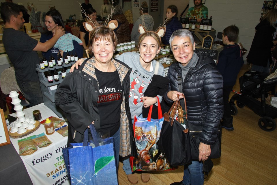 Gale Yandon, Liat Belillti, and Rhonda Marr picked up lots of Christmas gifts at the Newmarket Farmers' Market holiday market at the Newmarket Community Centre Saturday.  Greg King for NewmarketToday