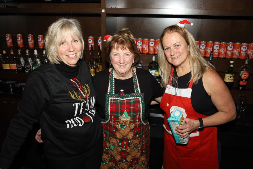 Sponsors and volunteers, lead by Deb Hatton and Jennifer McLachan, hosted a community dinner Christmas dinner at Cachet restaurant Dec. 25. Patty Thompson, Sue Scott and Trish Barnett volunteered to work the bar.  Greg King for NewmarketToday