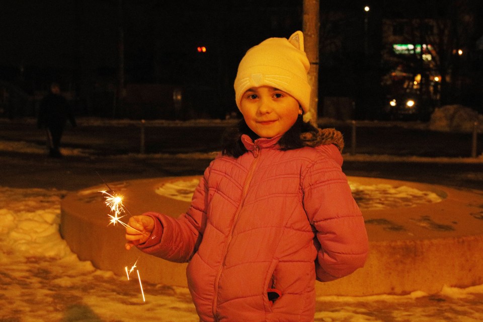 Katherine waves her sparkler in celebration of the arrival of 2021 at Riverwalk Commons with her family Dec. 31.  Greg King for NewmarketToday
