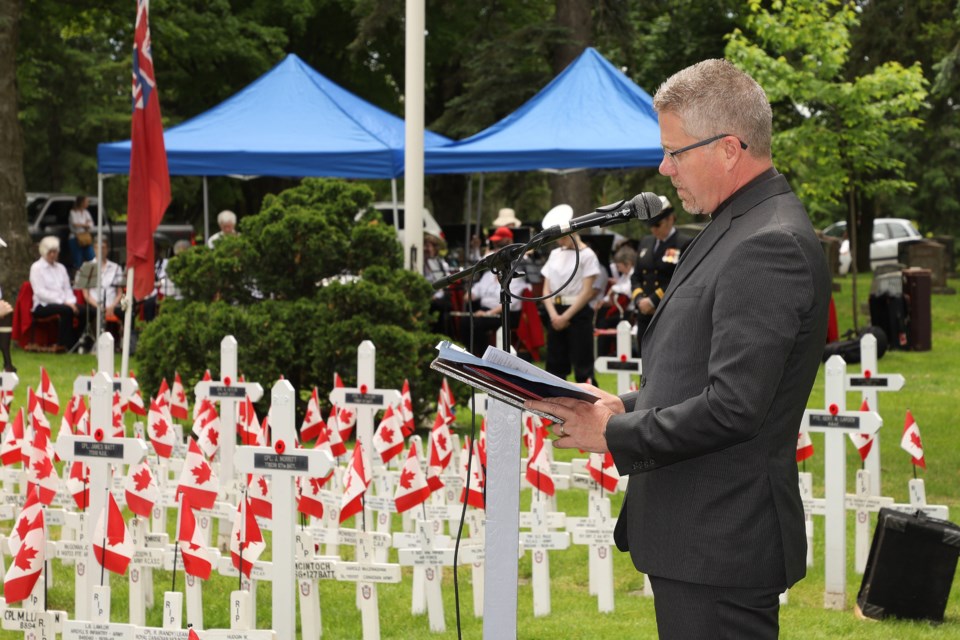 Rev. Michael Darrach gives the opening prayer at the Decoration Day service yesterday honouring Newmarket's war heroes.  Greg King for NewmarketToday