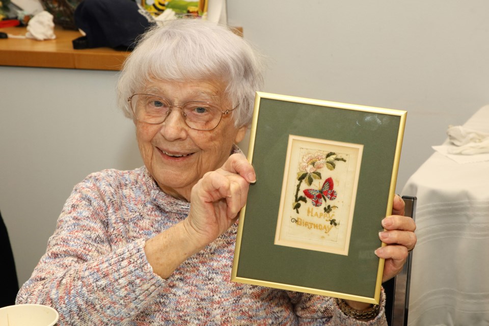 At the 'bring and brag' hosted by the Elman W. Campbell Museum March 3, Pamela Locke holds a birthday card sent by her great grandfather from France, where he served during the First World War.  Greg King for NewmarketToday