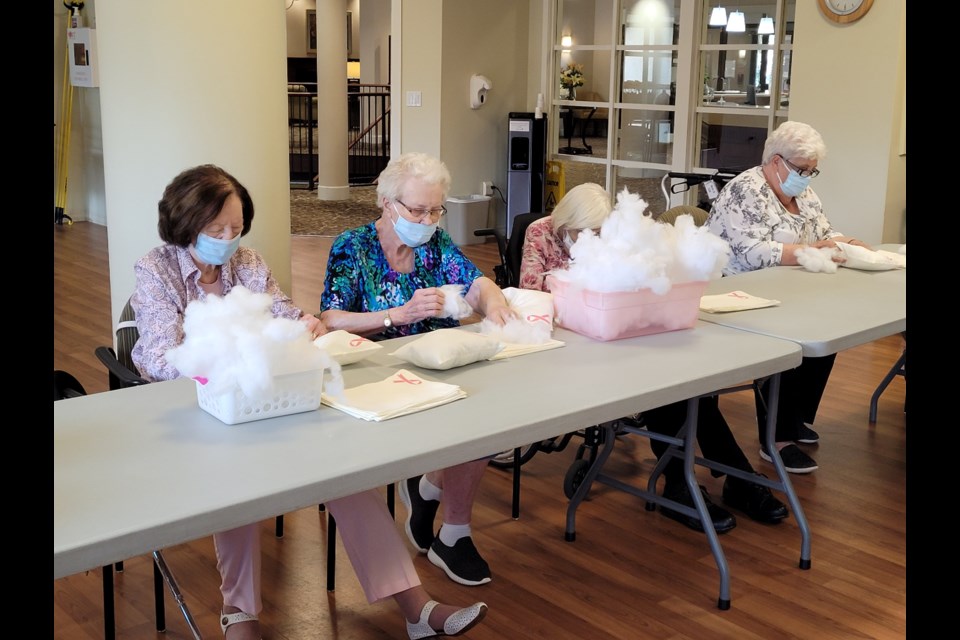 Ann Skillin (right) helping stuff pillows for breast cancer patients. 