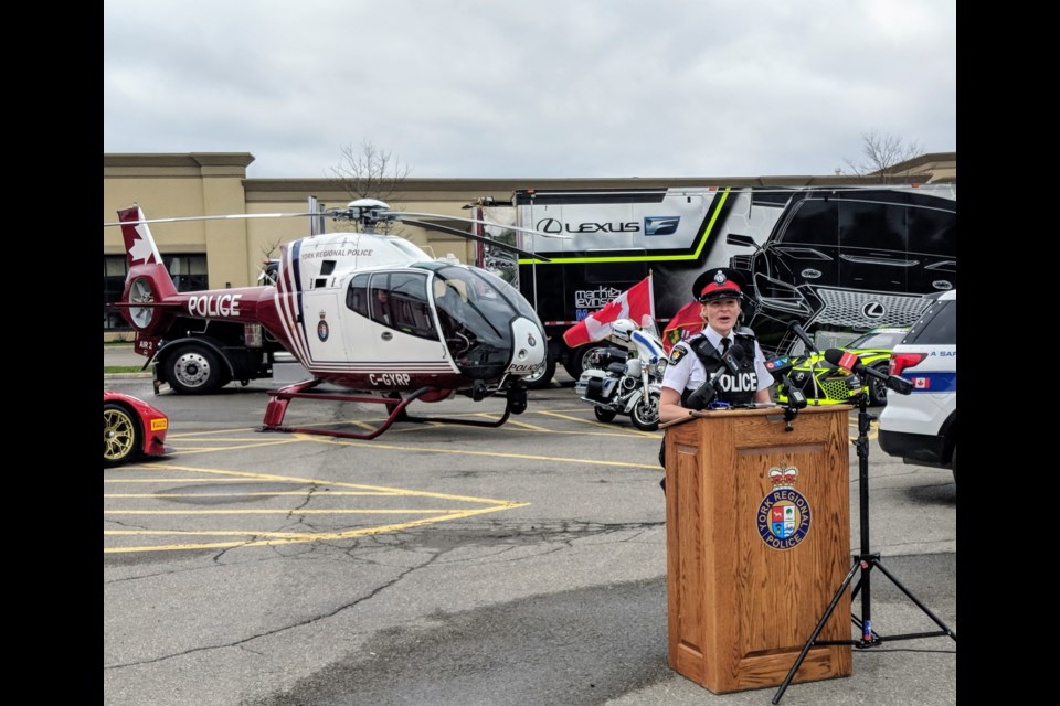 York Regional Police Staff Sgt. Sarah Riddell speaks May 10 at the kickoff of Project E.R.A.S.E. The York police Air2 helicopter is shown in the background. It is deployed to help catch street racers and stunt drivers. Kim Champion/NewmarketToday