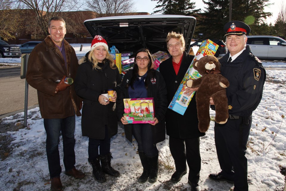 Newmarket Mayor John Taylor (from left), Newmarket Food Pantry director Juliane Goyette, Newmarket Soccer Club sponsorship coordinator Petra Fera, Newmarket Deputy Mayor Tom Vegh, York Regional Police Deputy Chief Brian Bigras mark the official launch of the Holiday Heroes toy and food drive Sunday at the Newmarket Soccer Club.  Greg King for NewmarketToday