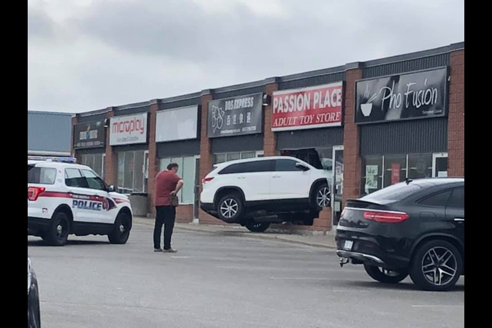An SUV at a plaza at Bayview Avenue and Mulock Drive went through the window of Passion Place this morning. Supplied photo/Heather Pollock Hill