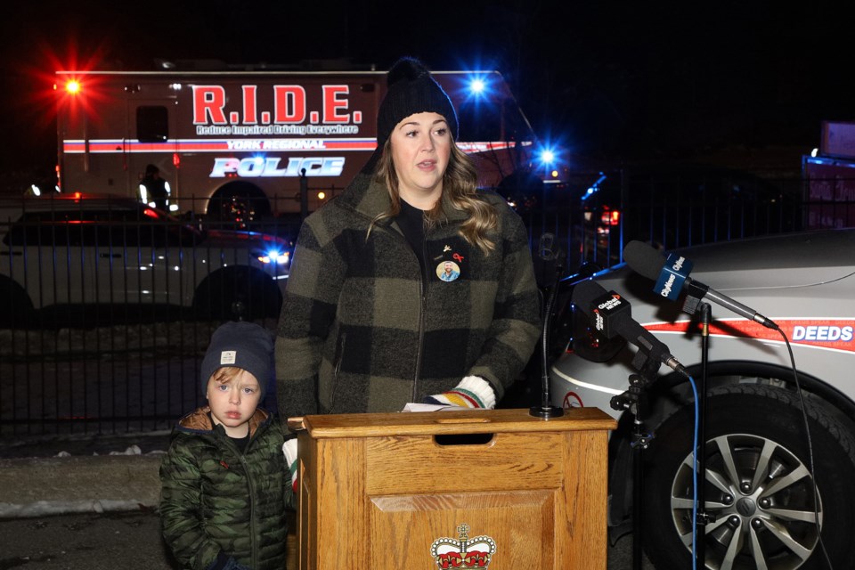 MADD representative Justine Ellis with her son, Coby, in Newmarket last night at the launch of York Regional Police's enhanced RIDE campaign during the holiday season.  Justine was pregnant with Coby when a drunk driver killed her husband, Stuart.  Greg King for NewmarketToday