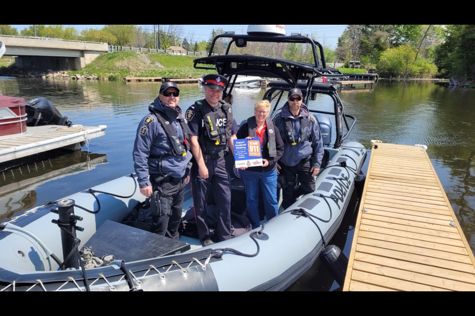 Staff Sgt. Aaron Busby, Const. Todd Snooks, Kathy Mitchell with MADD, and Sgt. Will McCue on one of York Regional Police's marine unit vessels. 