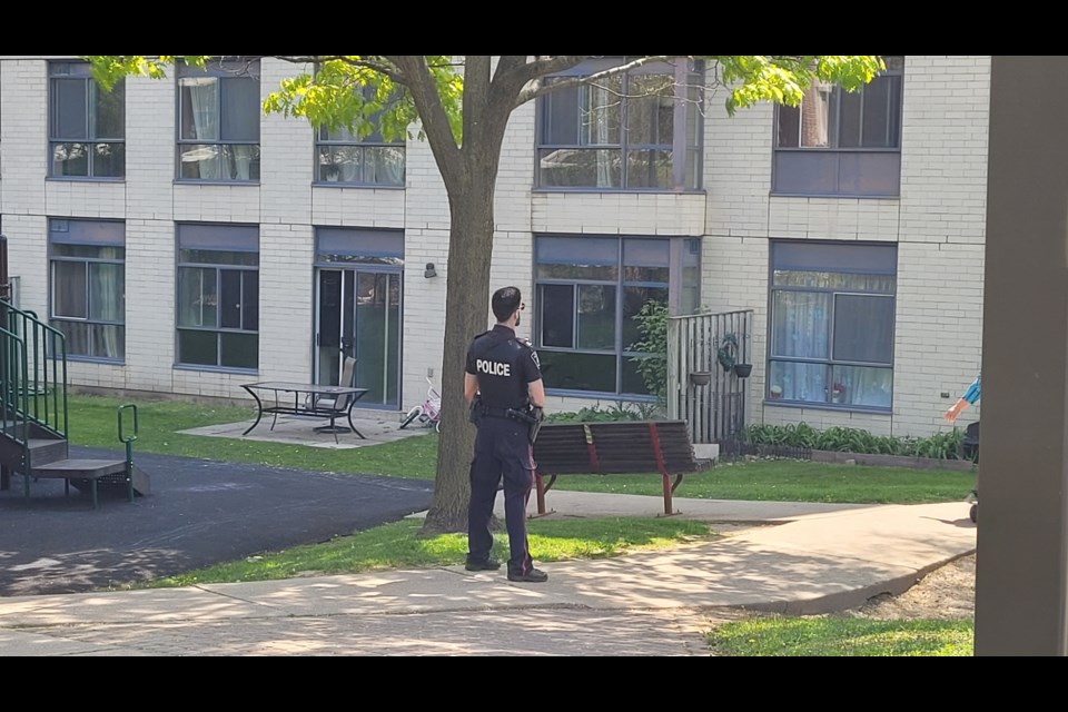 York Regional Police officers are stationed around the apartment building at Lorne and Davis, where a man with a knife is barricaded in a unit on Friday afternoon.