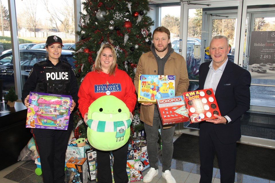 On the last day of the campaign, York Regional Police Const. Mandy Pattenden, York Regional Police Association special events co-ordinator Carrie Rutledge, Toronto Maple Leafs defenceman Morgan Rielly, and Mercedes Benz Newmarket managing partner Brian Fulton load up the van for YRP's annual Holiday Heroes toy and food drive for families in need across the region.