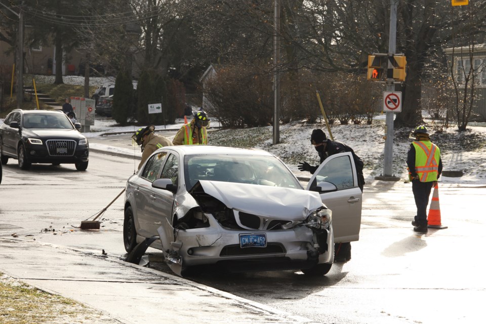 Central York Fire Services firefighters clean up debris following the two-car collision at Eagle Street and Lorne  Road Sunday, Dec. 20.  Greg King for NewmarketToday