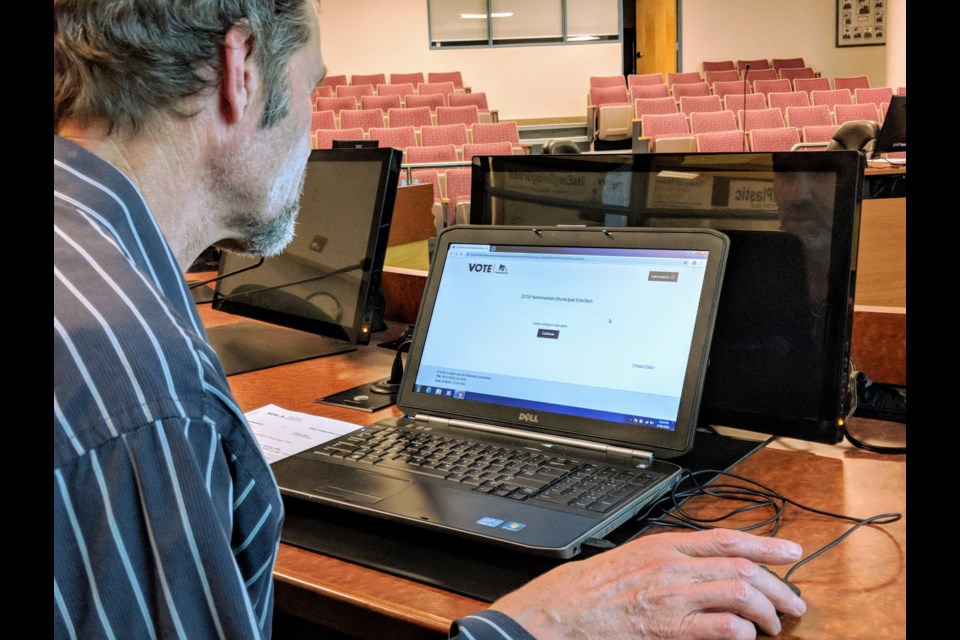 Newmarket resident Paul Cottenden takes a practice run at online voting at an election open house last night.