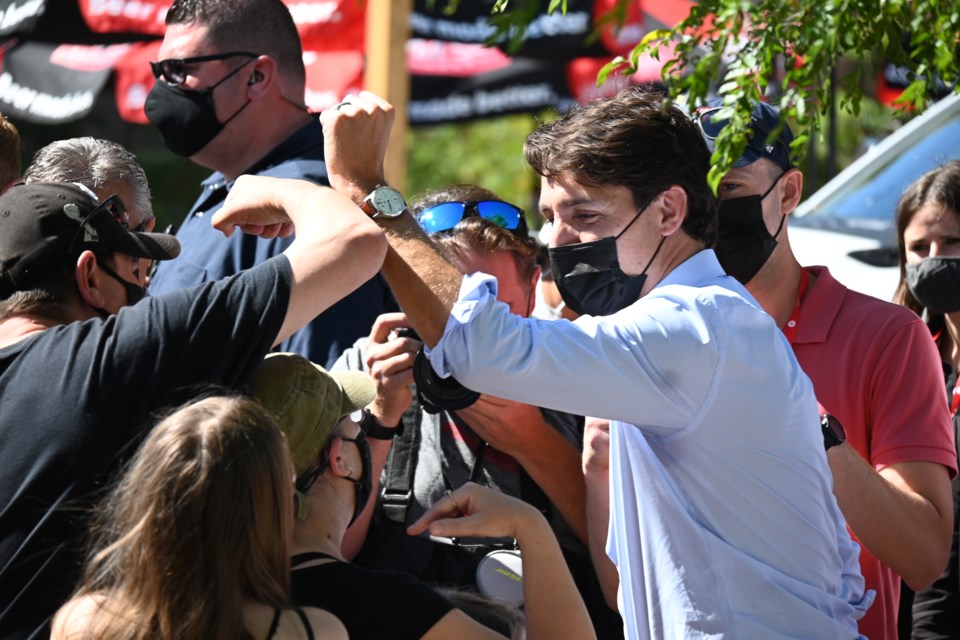 Liberal leader Justin Trudeau bumps arms with supporters during a campaign stop at the Newmarket Farmers' Market Sept. 18. 