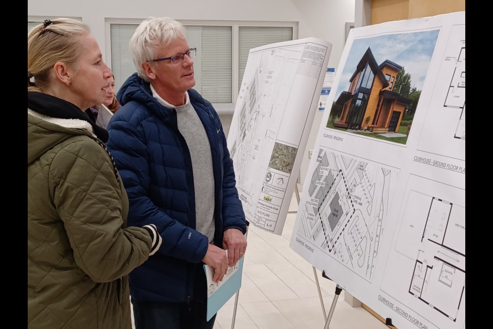 Newmarket Tennis Club members Andrea Mariash and Scott Mortimer look at town plans for a new clubhouse.