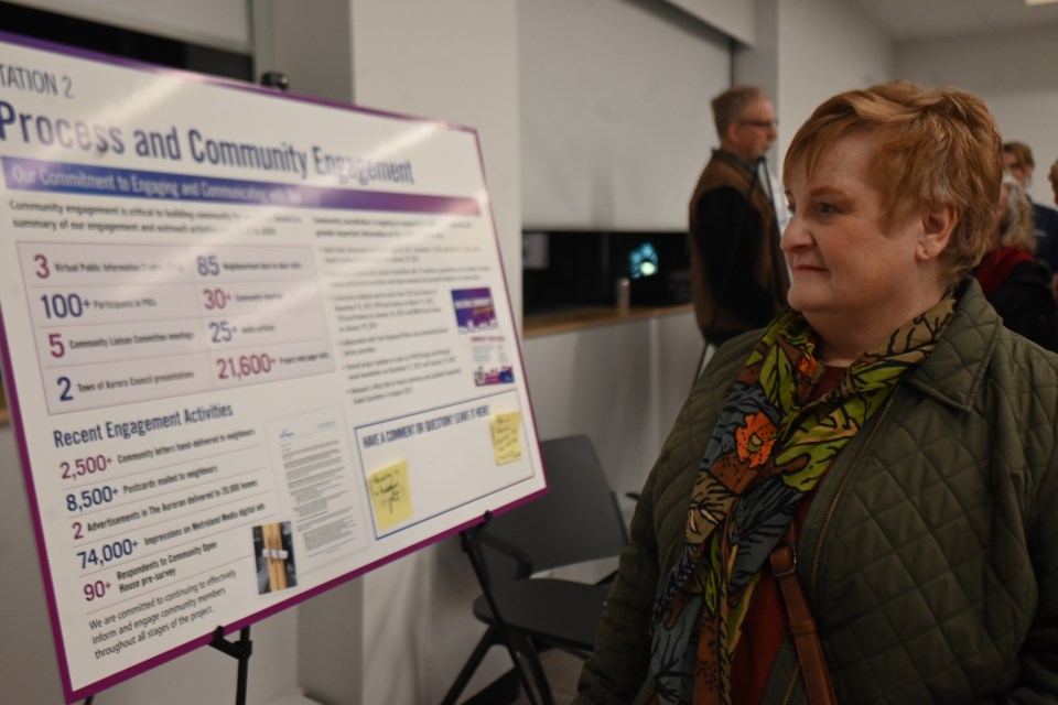 Aurora resident Kimberley McLean views one of the displays at the open house for a new shelter project.