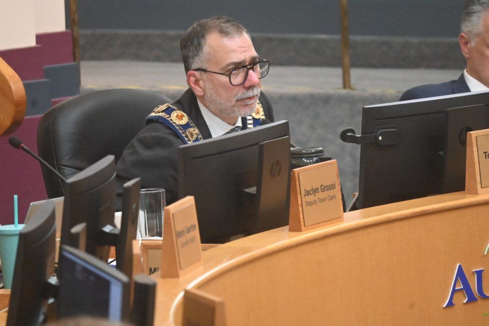 Aurora Mayor Tom Mrakas tried to manage the presentations and crowd during the meeting. 